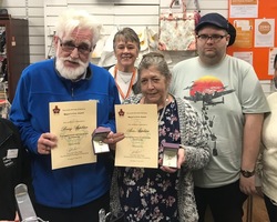 Barry and Ann Appleton proudly show off their Civic Awards with store Manager Mary Banks and fellow 