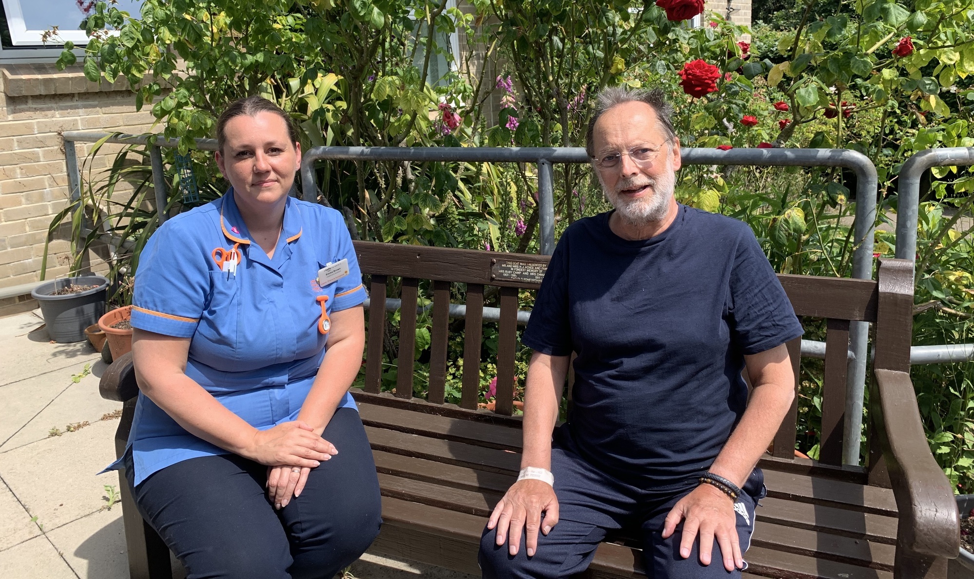Emma Brown HCA and Steve Haim sitting on a bench in the garden crop