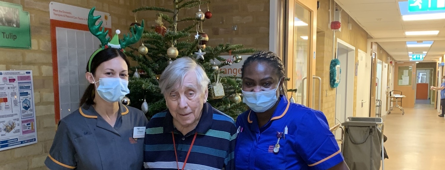 Jo Noguera with a patient and fellow nurse by the Christmas tree (cropped)