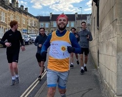 A smiling Zack on the run with his friends for support (cropped)