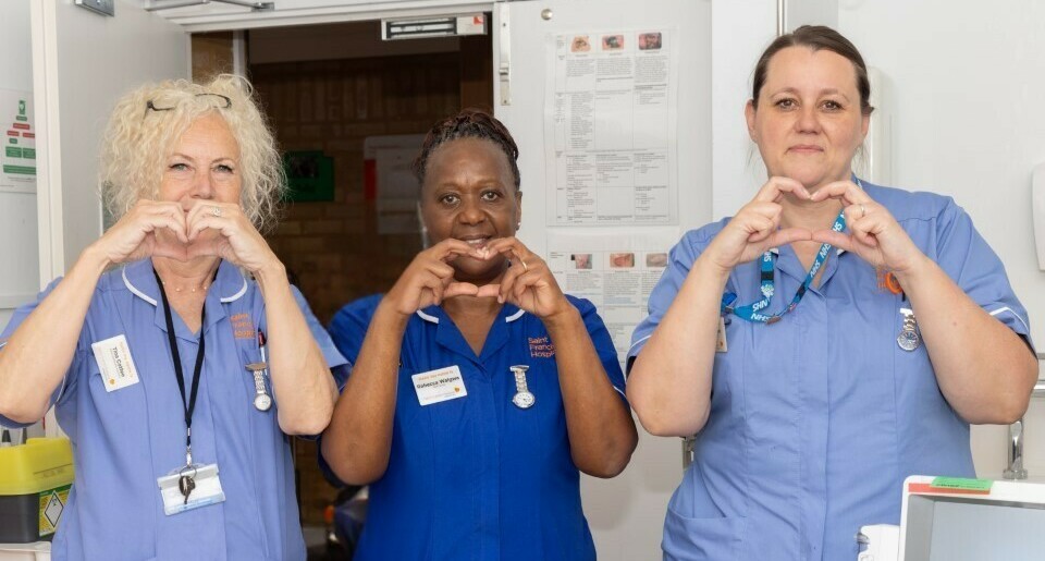 staff making the heart sign (cropped)