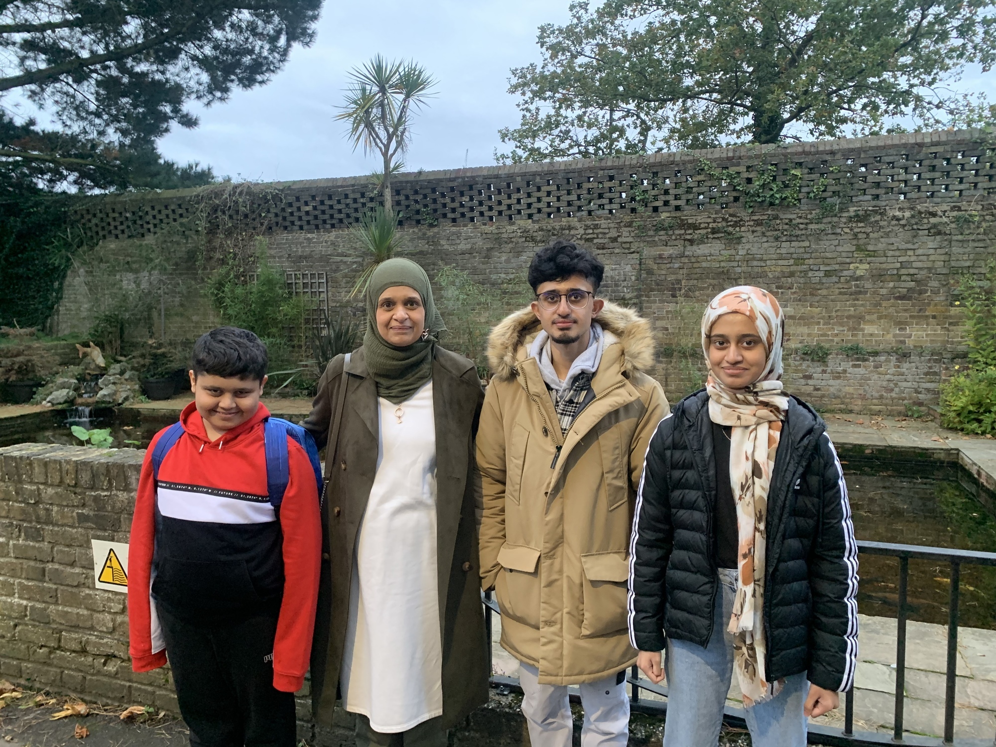 L-R Anees, Vanessa, Awais and Sabaa by the pond at the hospice
