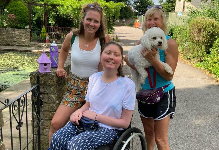 Ria by the Victorian pond at the hospice with Kaz, her mum and dog (cropped)