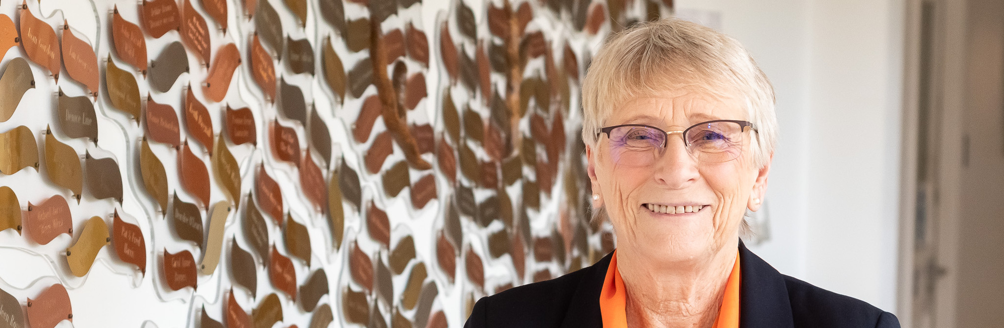 Volunteer Jenny Hodgson in front of the memory tree (cropped) (cropped)