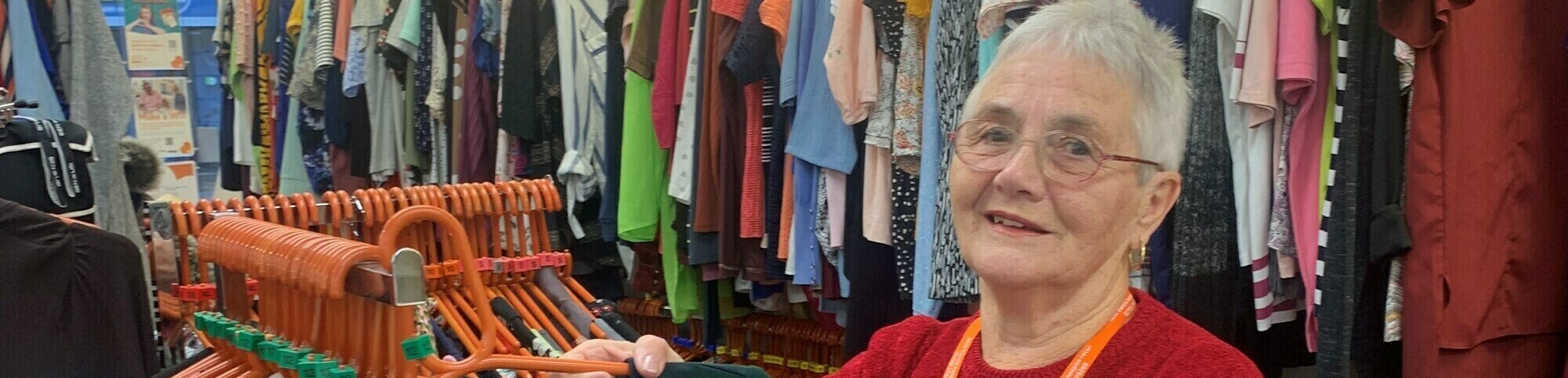 Peggy sorting clothes on a rail crop (cropped)