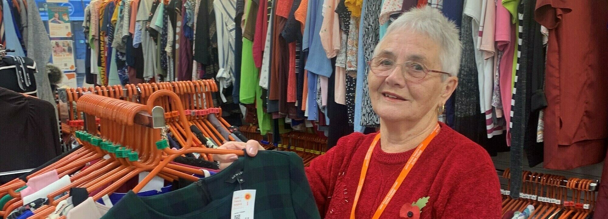 Peggy sorting clothes on a rail crop (cropped)