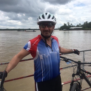 Keith Crossman standing by bike