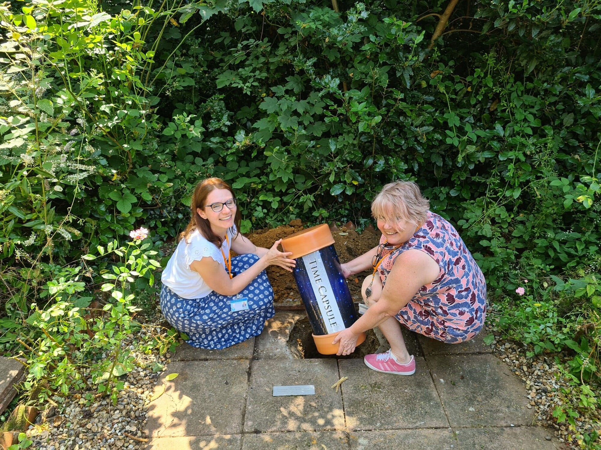 Emily Gray and Sarah-Jane Higbee bury the capsule