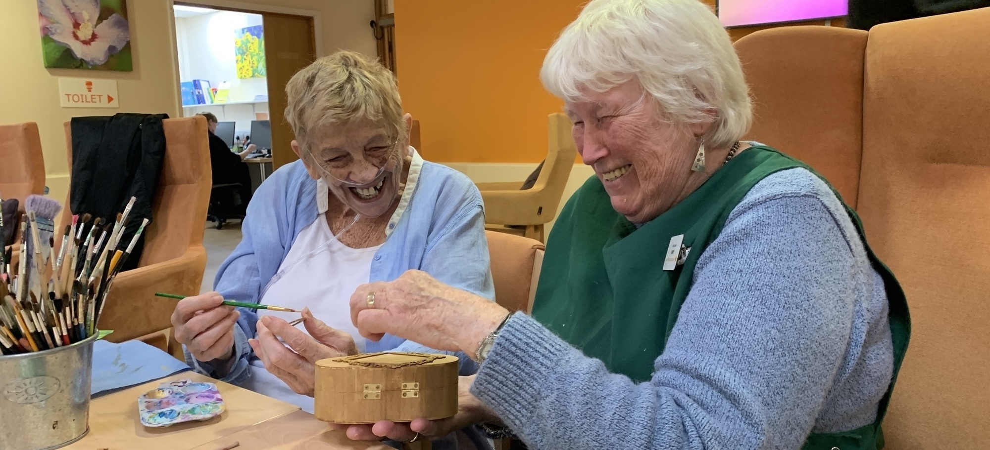 Volunteer Mary and patient Christine Smith share a laugh 2 (cropped)