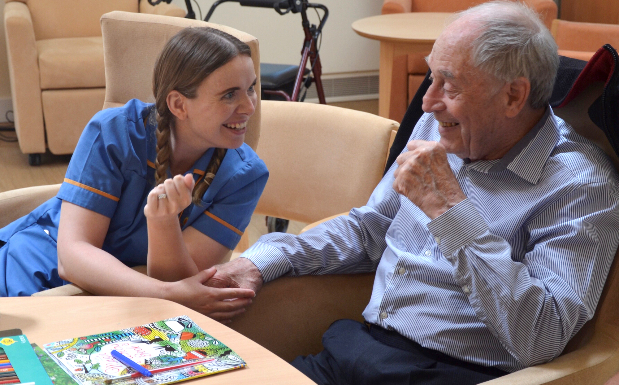 Healthcare Assistant Aimee Mabbort laughing with a patient