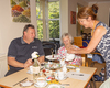 Marion serving tea to Chris and family